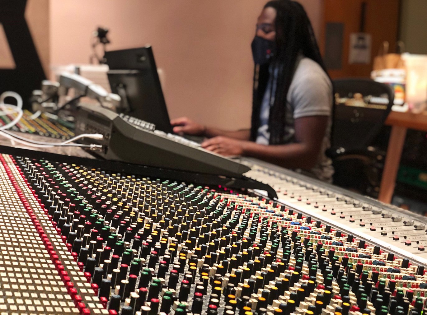 person sitting in front of soundboard