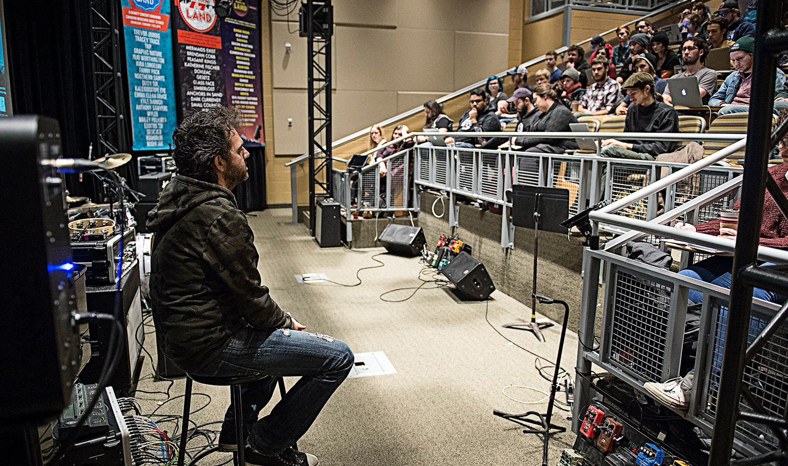 Craig Mann sitting in chair in front of students